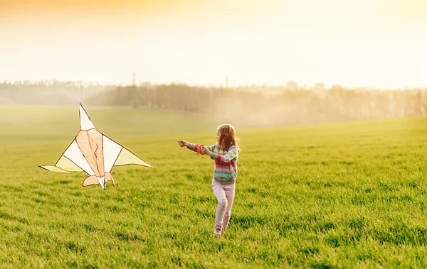 Klein meisje met vliegende vlieger — Stockfoto