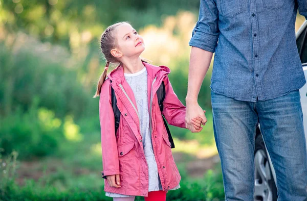 Flicka tittar upp på far innan skolan — Stockfoto