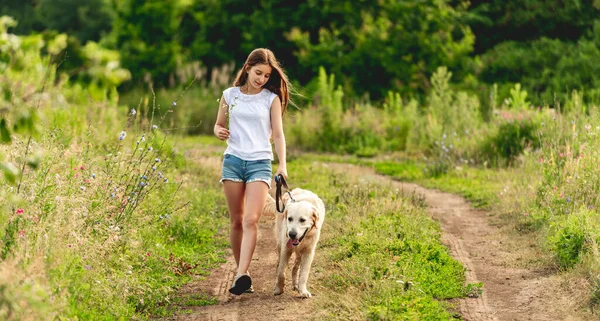 Cute little girl running with dog — Stock Photo, Image