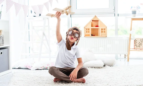 Happy little boy playing with plane — Stock Photo, Image