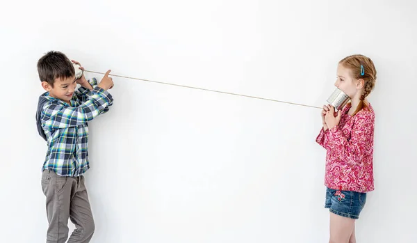 Children playing with self made telephone — Stock Photo, Image