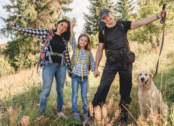 Happy family trekking in sunny mountains — Stock Photo, Image