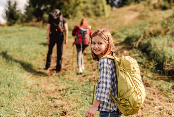 Smiling little girl trekking in mountains — Stock Photo, Image