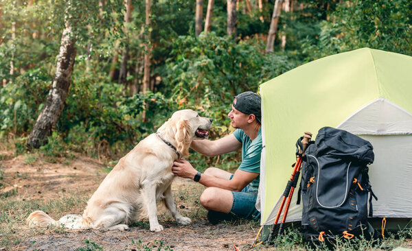 Man with dog next to tent