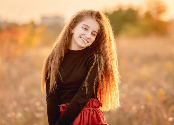 Happy teenage girl walking in autumn nature — Stock Photo, Image