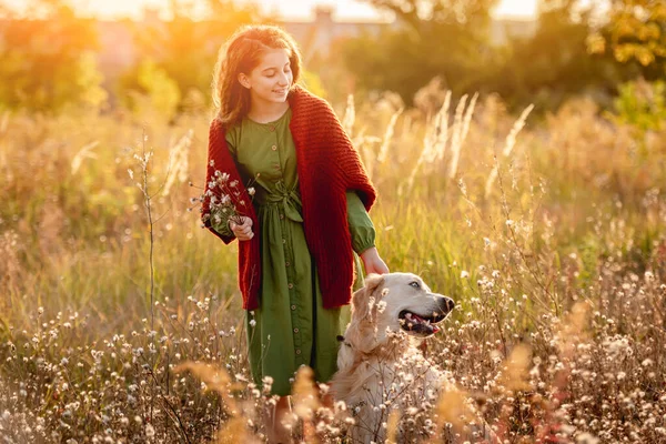Young girl petting dog in nature — Stock Photo, Image