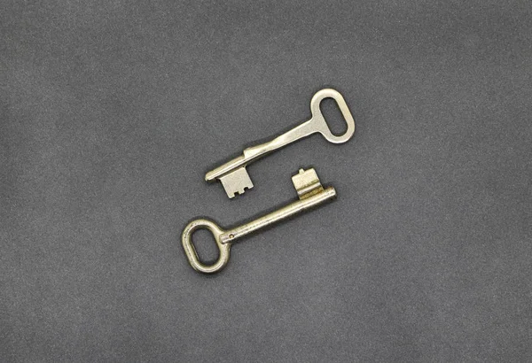 Two Old Simple Metal Keys Gray Paper Background Close — Stock Photo, Image