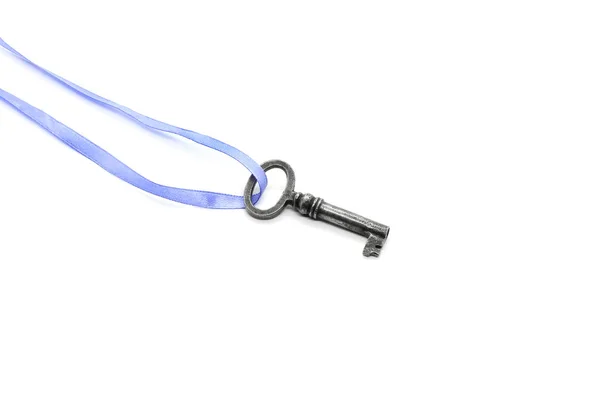 Vintage silver key on blue ribbon on white background — Stock Photo, Image