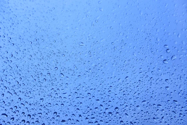 Gocce d'acqua su vetro, texture naturale blu — Foto Stock