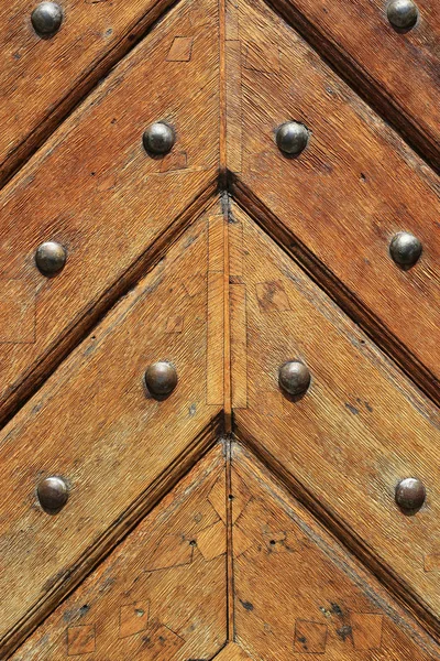 Closeup of old vintage wooden doors with metal rivets — Stock Photo, Image
