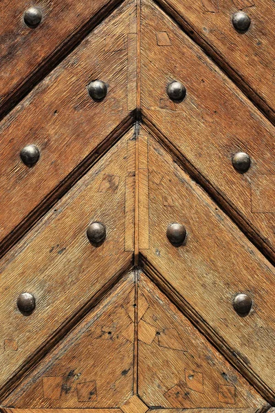Fragment of old wooden doors with metal rivets — Stock Photo, Image