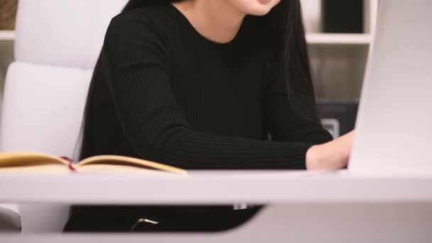 Businesswoman in her office. Typing something on her laptop and smiling. — Stock Video