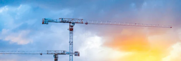 Construction cranes on blue sky background — Stock Photo, Image