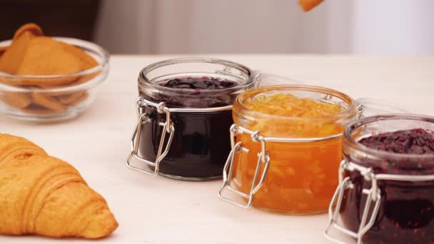 Unrecognizable person dipping cookie into jam — Stock Video