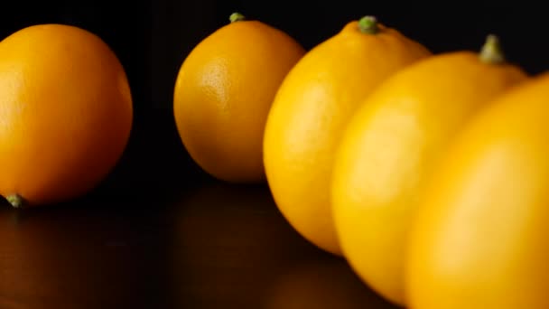 Lemon rolling into row of fruits — Stock Video