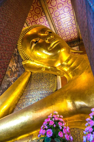Giant Reclining Buddha inside Wat Pho Temple in Bangkok in a summer day