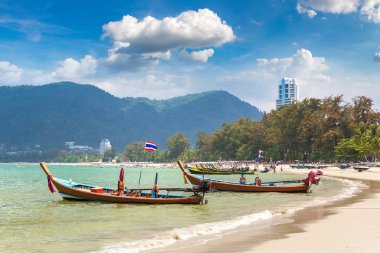 Traditional long tail boat on Patong beach and Andaman sea on Phuket in Thailand in a summer day clipart