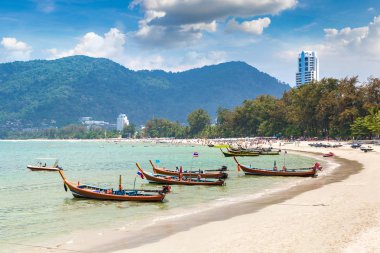 Traditional long tail boat on Patong beach and Andaman sea on Phuket in Thailand in a summer day clipart