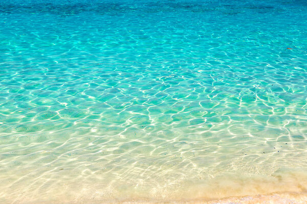 Clear water reflections on shallow sandy beach bottom, Thailand in a summer day