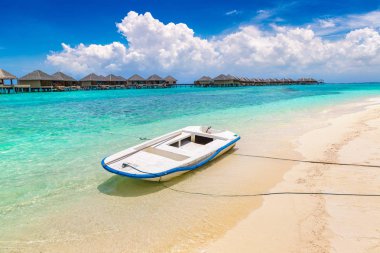 MALDIVES - JUNE 24, 2018: Boat at Tropical beach in the Maldives at summer day clipart