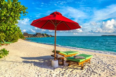 Maldivler - 24 Haziran 2018: Ahşap şezlong ve şemsiye yaz günü, Maldivler tropik sahilde