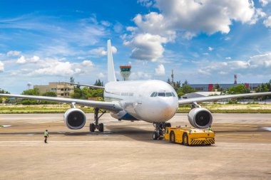 Airplane ready to take off at Velana International Airport in Male, Maldives in a summer day clipart