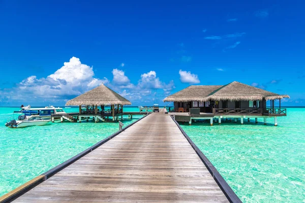 Maldivler - 24 Haziran 2018: Su Villa (Bungalov) ve yaz akşam Maldivler'de tropik sahilde ahşap köprü
