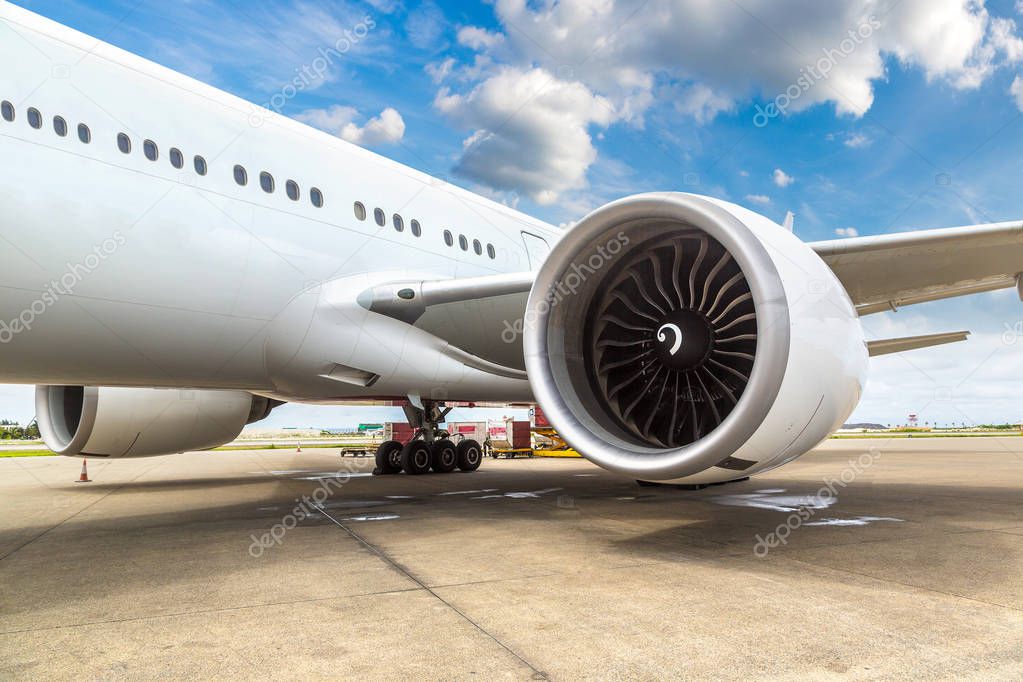 Airplane and engine at Velana International Airport in Male, Maldives in a summer day