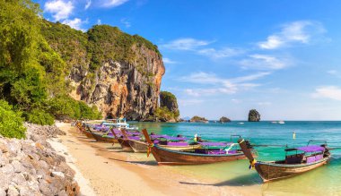 Panorama of  Traditional long tail boat on Ao Phra Nang Beach, Krabi, Thailand in a summer day clipart
