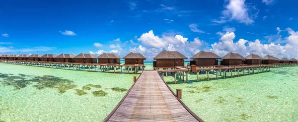 Panorama of Water Villas (Bungalows) at Tropical beach in the Maldives at summer day