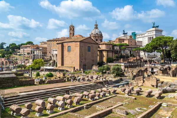 ROME, ITALY - JULY 12, 2014: Ancient ruins of Forum and Victor Emmanuel II monument in a summer day in Rome, Italy