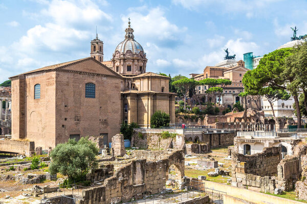 ROME, ITALY - JULY 12, 2014: Ancient ruins of Forum and Victor Emmanuel II monument in a summer day in Rome, Italy