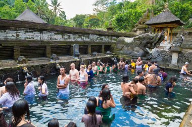 BALI, INDONEZYA - 28 Şubat 2020: Bali halkı Endonezya 'nın Bali kentindeki Pura Tirta Empul Tapınağı' ndaki kutsal havuzda dua ediyor