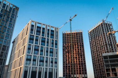 Betonarme ve tuğla binalar ve vinçler ile şantiye. Modern metropol konut kavramı 