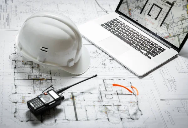 White hard hat, laptop  with drawings, glasses and walkie talkie — 스톡 사진