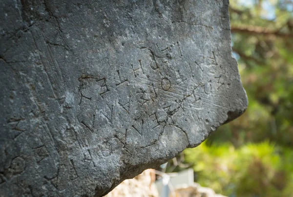 Texto grego esculpido em pedras antigas de Phaselis ruínas, g antient — Fotografia de Stock