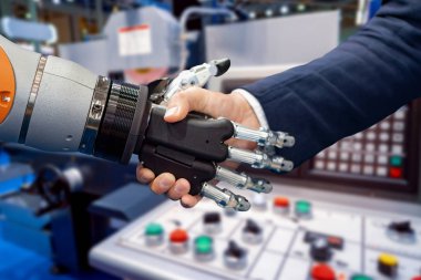 Android bir robotla el sıkışan bir iş adamının eli. Yapay zekayla insan etkileşimi kavramı.