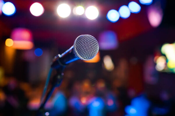 Public performance on stage Microphone on stage against a background of auditorium. Shallow depth of field. Public performance on stage.