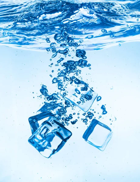 Ice cubes falling under water — Stock Photo, Image