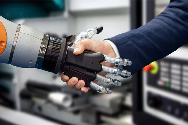 Hand of a businessman shaking hands with a Android robot. — Stock Photo, Image