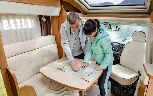 Couples in RV Camper looking at the local map for the trip. — Stock Photo, Image