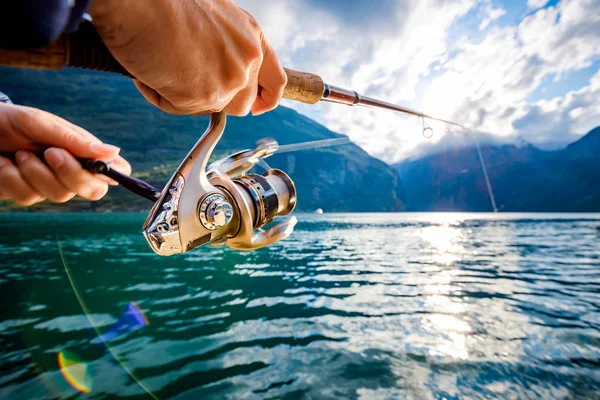 Woman fishing on Fishing rod spinning in Norway. — Stock Photo, Image