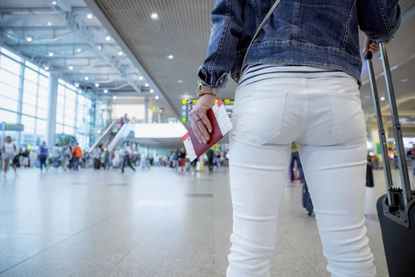 Mujer Viajero tiene un pasaporte y un billete contra la espalda —  Fotos de Stock