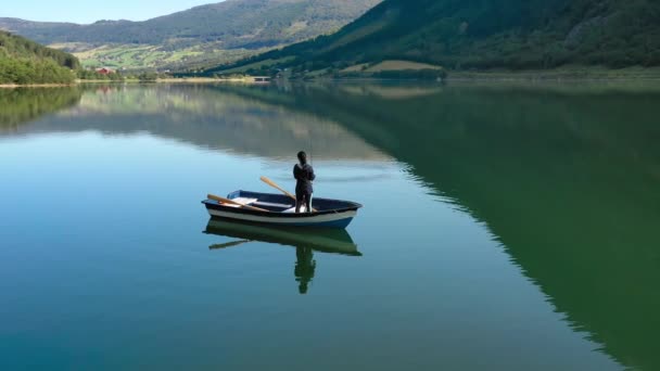 Woman on the boat catches a fish on spinning in Norway. — Stock Video