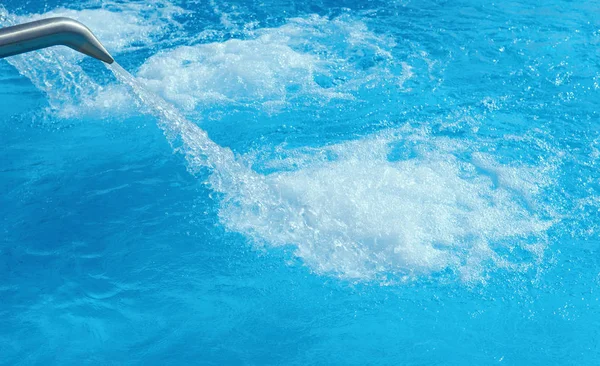 Swimming pool with streams of water — Stock Photo, Image