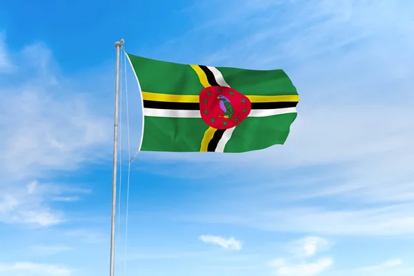 Dominica vlag over blauwe hemel achtergrond — Stockfoto