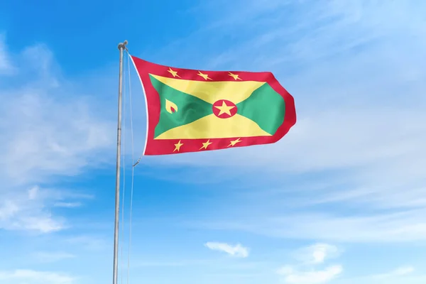 Grenada vlag over blauwe hemel achtergrond — Stockfoto
