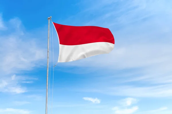 Indonesia flag over blue sky background — Stock Photo, Image