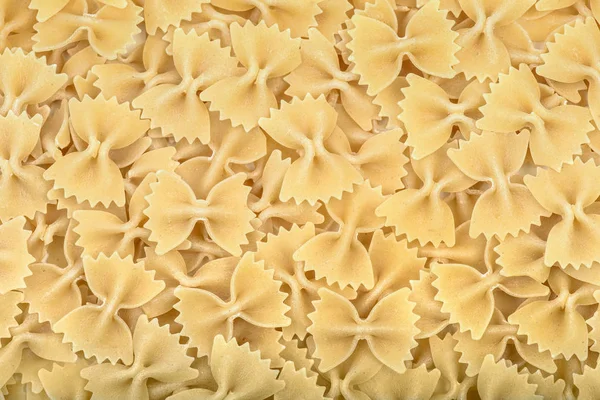 Farfalle tie bow shaped italian pasta background or texture — Stock Photo, Image