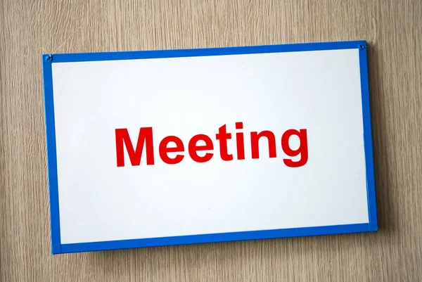 meeting sign on the door of the conference room